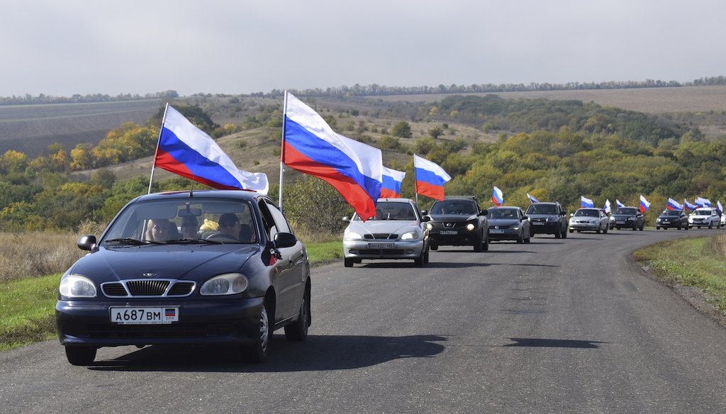 A motorcade with Russian national flags drive during celebrations marking the annexation of the Donetsk region into Russia in Donetsk, Ukraine, Friday, Sept. 30, 2022. The annexation was critized by world leaders as a violation of international law. (AP)