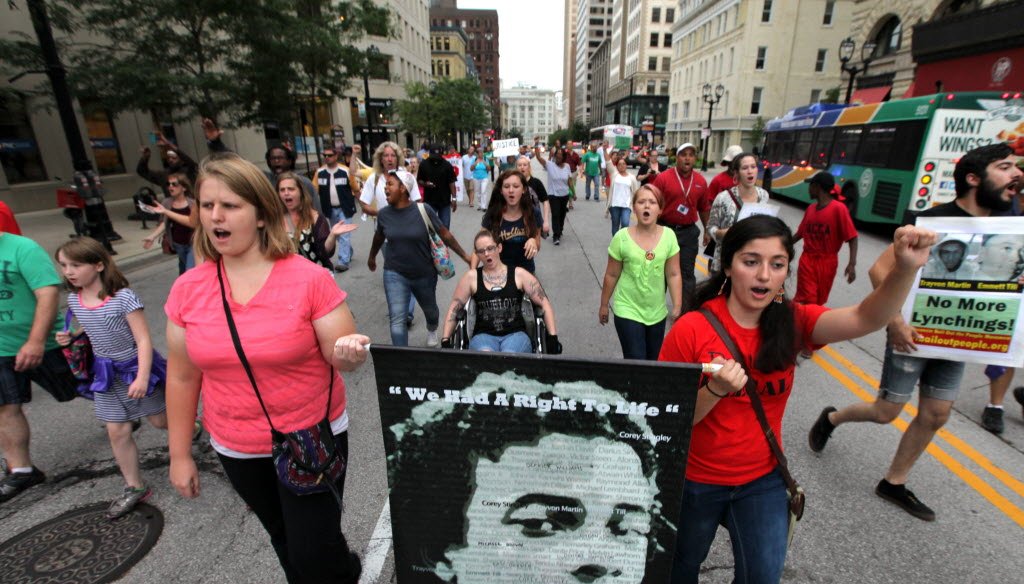 Demonstrators marched in downtown Milwaukee on Aug. 25, 2014 to raise awareness about the fatal police shootings of Dontre Hamilton in Milwaukee and Michael Brown in Ferguson, Mo.