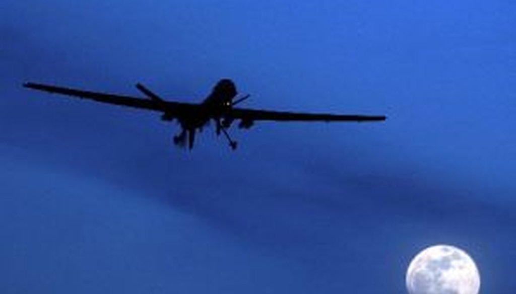 An unmanned United States Predator drone flies over Kandahar Air Field in Afghanistan on a moon-lit night in a Jan. 31, 2010, file photo.