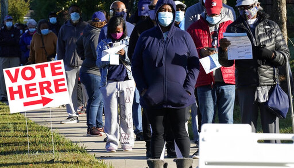 Early voters line up to cast their ballots at the South Regional Library polling location in Durham, N.C., Thursday, Oct. 15, 2020. (AP)