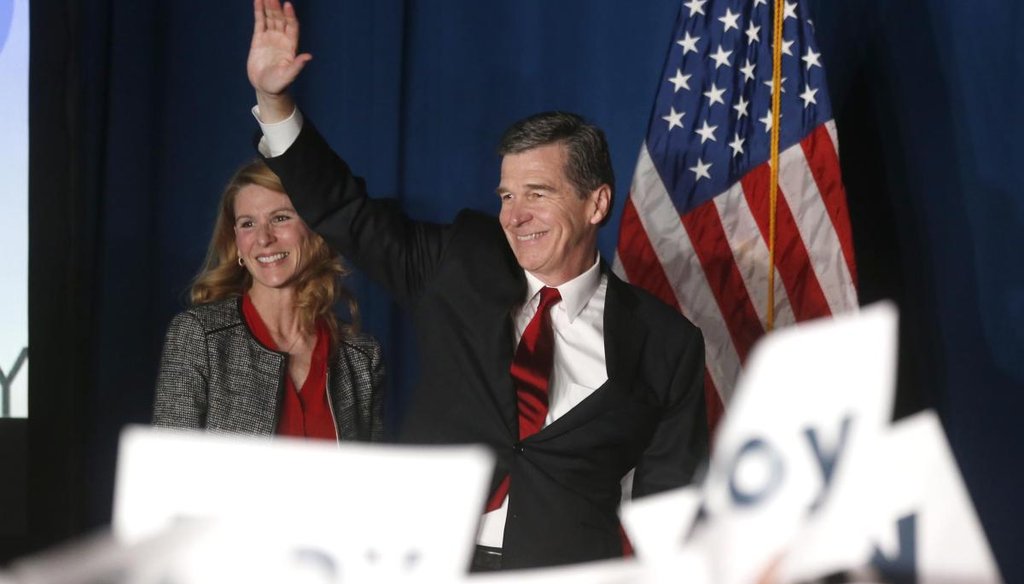 Roy Cooper waves to supporters on election night in Raleigh. News & Observer photo.