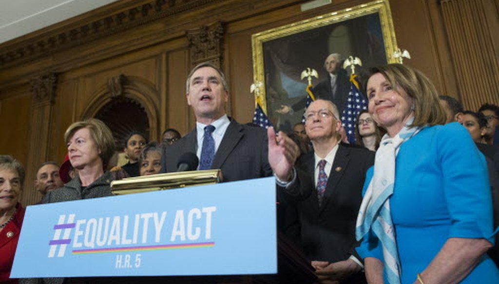 Oregon Sen. Jeff Merkley (center) comments during an event to introduce the Equality Act March 13, 2019 in Washington. Also attending is Wisconsin Sen. Tammy Baldwin (left) and House Speaker Nancy  Pelosi. (Michael Reynolds)