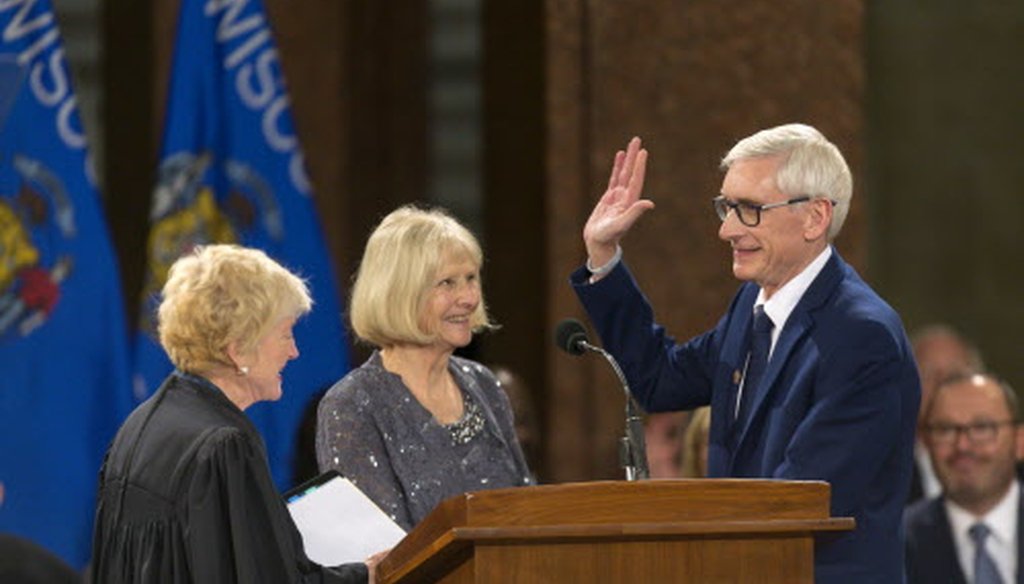 Wisconsin Gov. Tony Evers (right) is sworn in by Wisconsin Supreme Court Chief Justice Pat Roggensack as Kathy Evers watches during the inauguration ceremony at the state Capitol Jan. 7, 2019, in Madison, Wis. (Andy Manis / Associated Press)