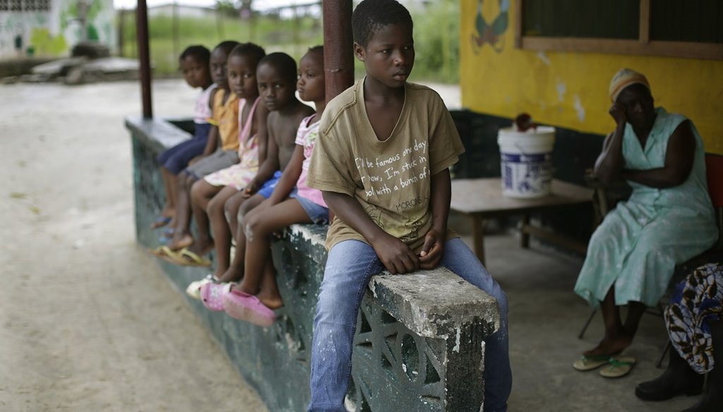 Children sit at a bench in an orphanage in Liberia. (AP Photo)