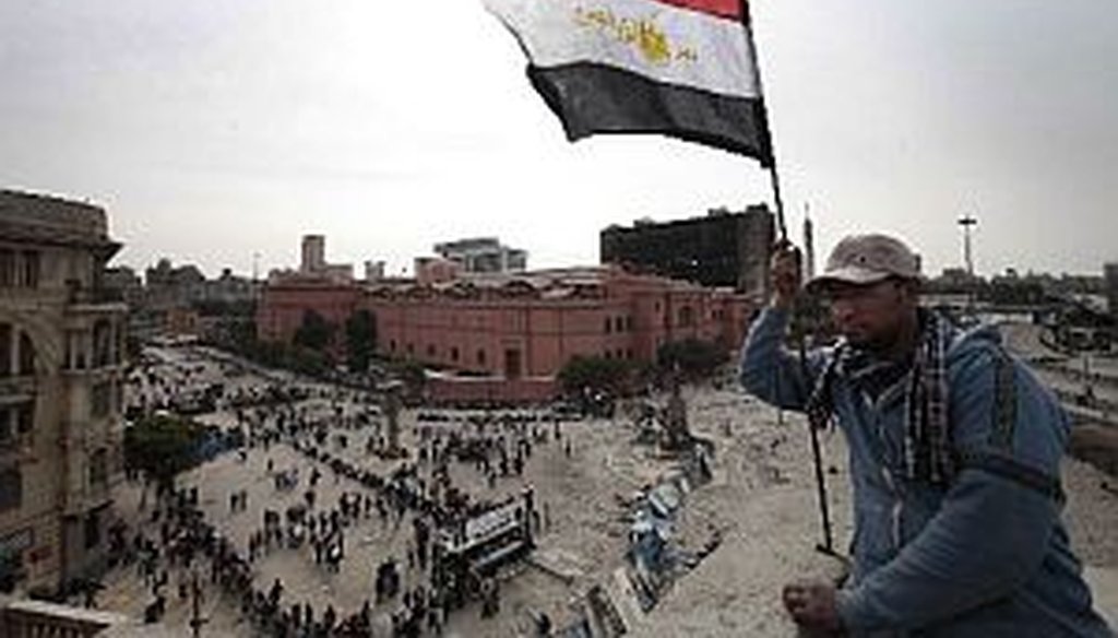 An anti-government protester waves an Egyptian flag in Cairo on Friday