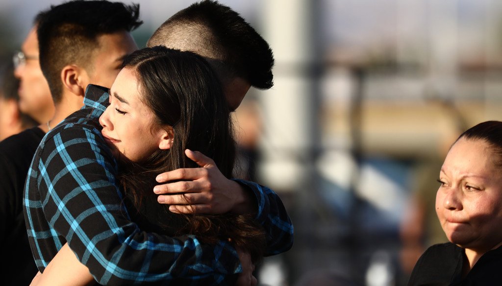 Mourners embrace at a vigil honoring Horizon High School sophomore Javier Amir Rodriguez, who lost his life in a mass shooting in nearby El Paso, on August 5, 2019 in Horizon City, Texas. (Photo by Mario Tama/Getty Images)