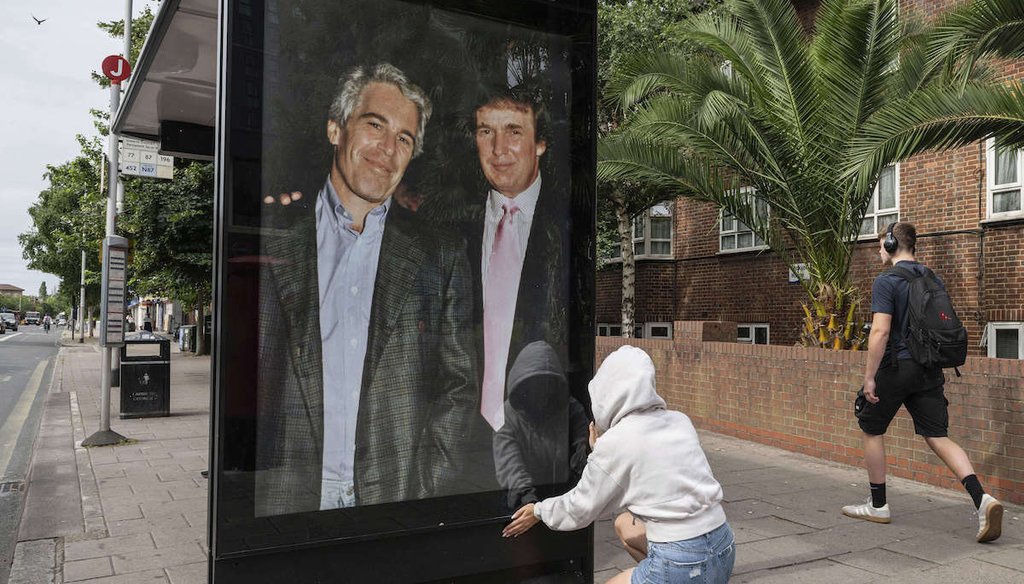 Activists put up a poster showing President Donald Trump and Jeffrey Epstein near the U.S. Embassy in London, July 17, 2025. (AP)