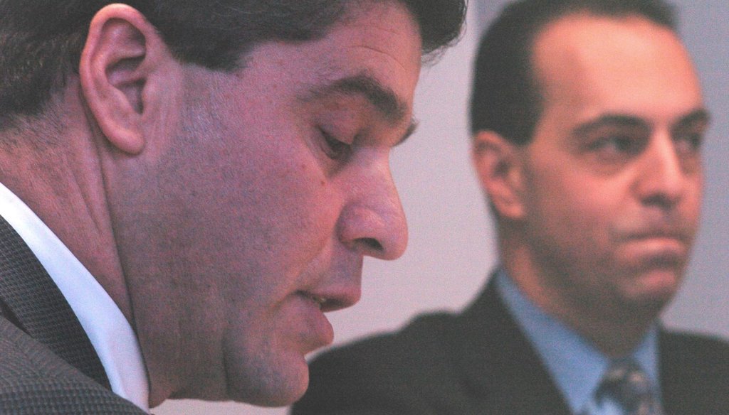 Ernest Almonte (left) when he was Rhode Island's auditor general during a March 2004 meeting with North Providence officials on the town's financial problems. Then-Mayor Ralph Mollis listens in the background. (The Providence Journal / Bob Thayer)