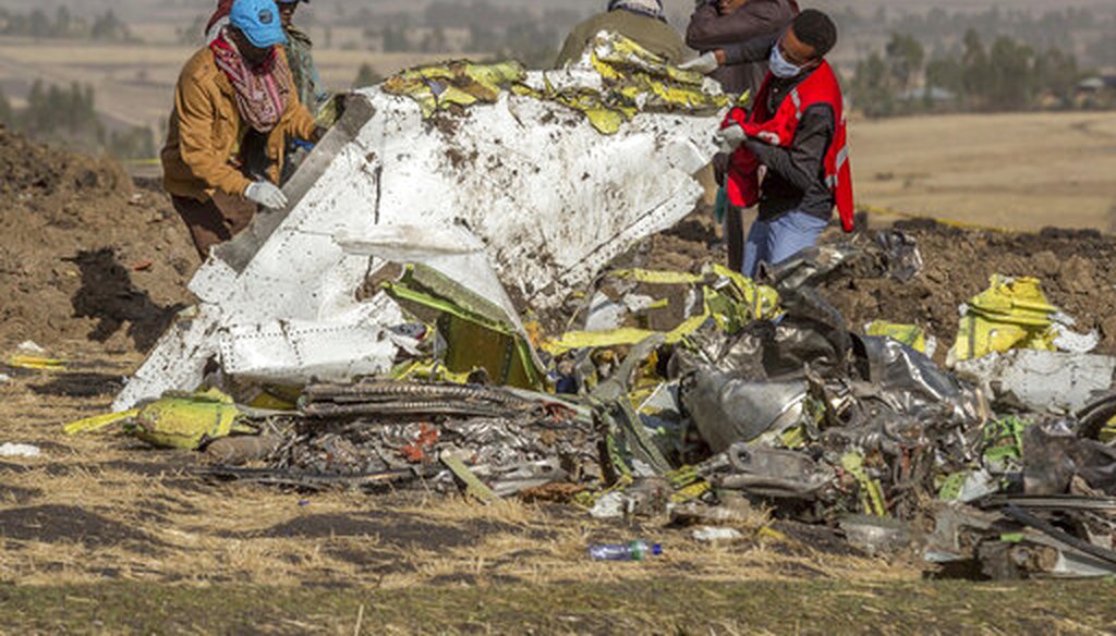 Rescuers work at the scene of an Ethiopian Airlines flight crash south of Addis Ababa, Ethiopia.  (AP Photo/Mulugeta Ayene)