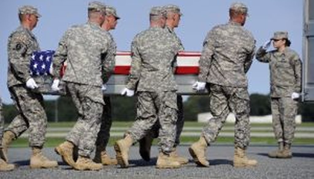 An Army team carries a transfer case containing the remains of Army Sgt. Devin Daniels, of Kuna, Idaho, who died in Afghanistan.