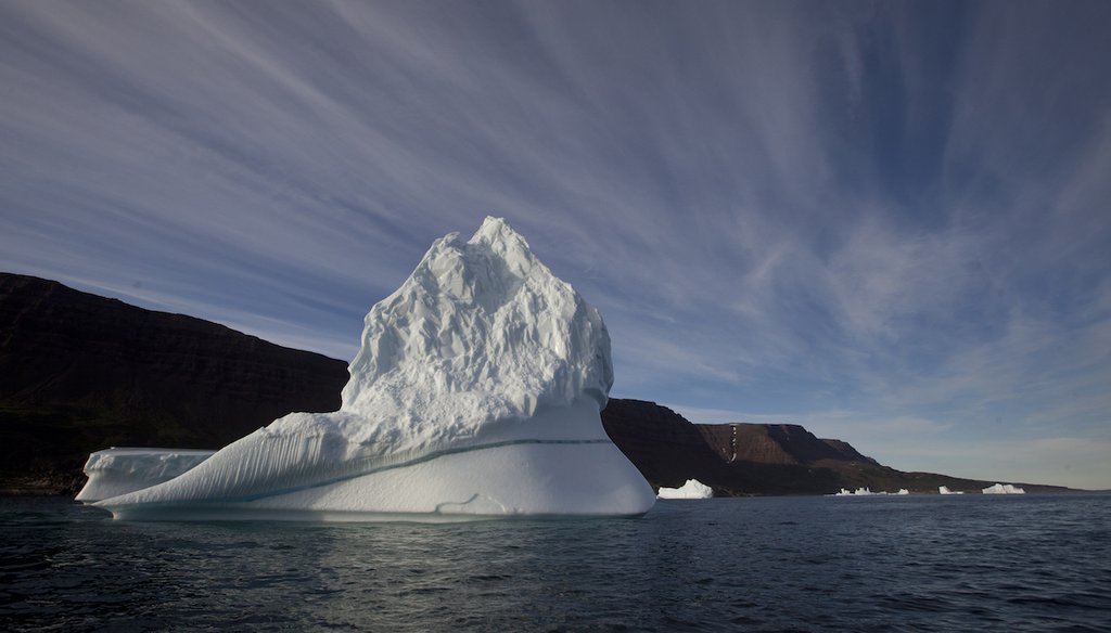 This July 2011 file photo shows an iceberg floating in the sea near Greenland. A NASA study found that global warming is shifting the way the Earth wobbles on its polar axis. (AP Images)