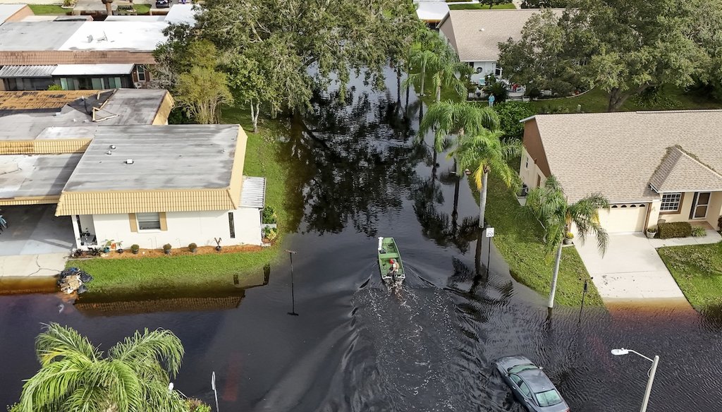 A member of the Pasco County Sheriff's Office goes out to help residents trapped in their homes as waters rise after Hurricane Milton caused the Anclote River to flood, Oct. 11, 2024, in New Port Richey, Fla. (AP)