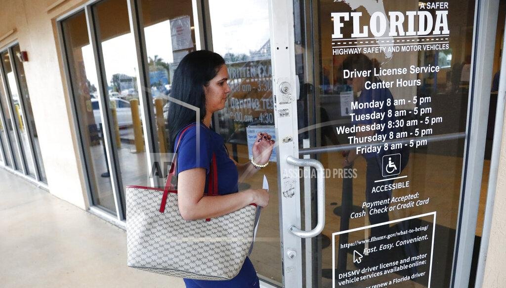 A woman enters a Florida Highway Safety and Motor Vehicles drivers license service center, Tuesday, Oct. 8, 2019. (AP)