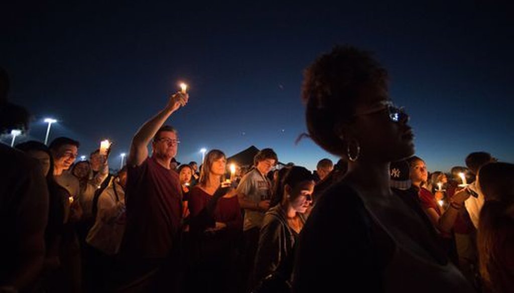 A candlelight vigil was held the day after the mass shooting at a Florida high school. (USA Today Network)
