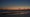A sunset sky reflects off of water surrounding a sandbar just off the coast of Horseshoe Beach, Fla., Wednesday, May 8, 2024. (AP)