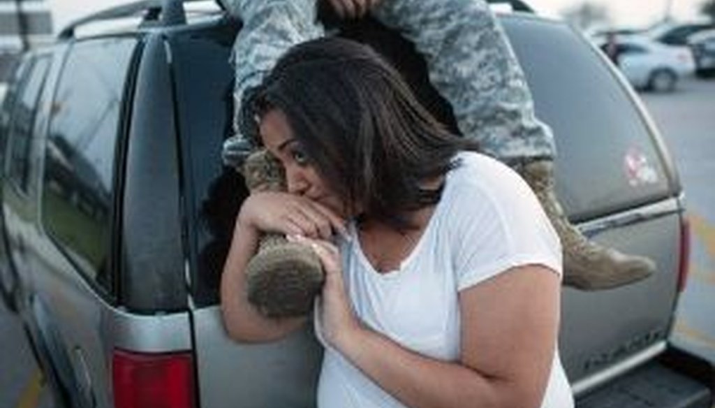Lucy Hamlin and her husband, Spc. Timothy Hamlin, wait for permission to re-enter the Fort Hood military base, where they live, following a shooting on the base. (AP)
