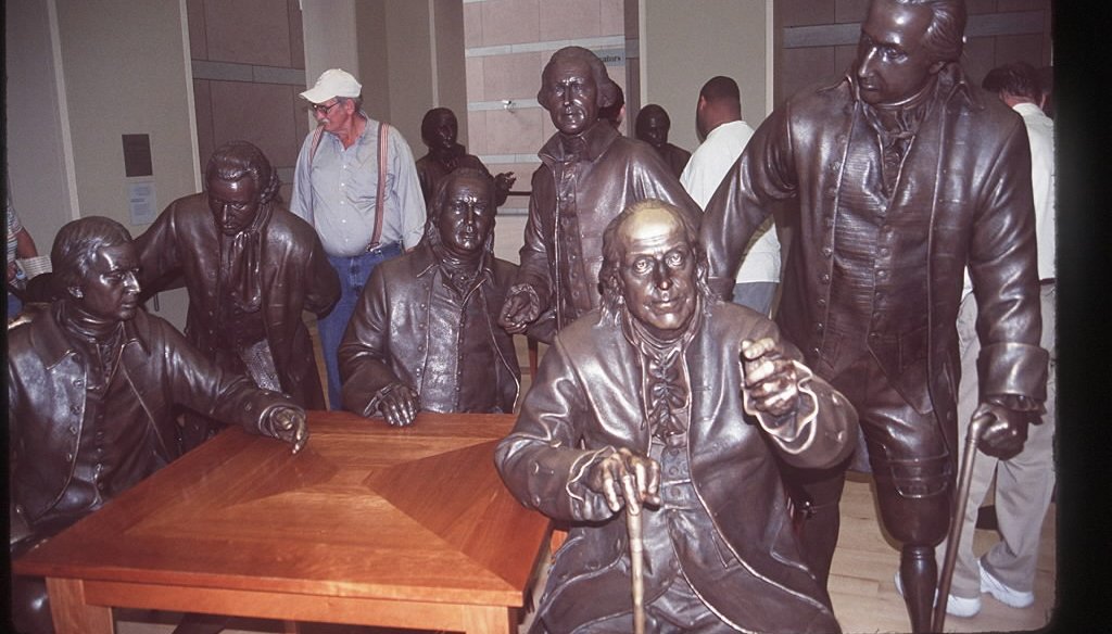 A statue of Benjamin Franklin sits amid the Founding Fathers in the National Constitution Center in Philadelphia. (KRT photo)