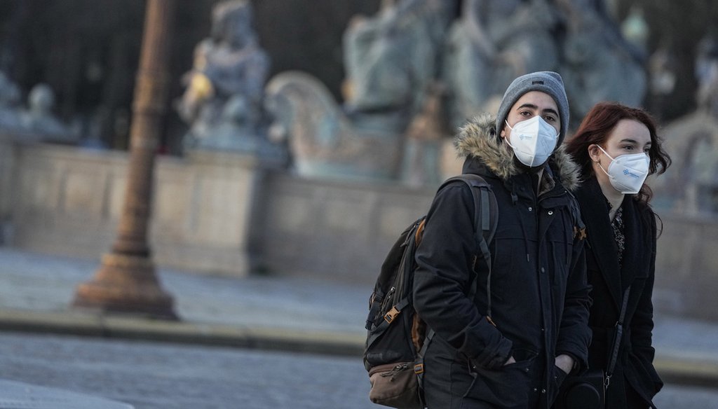People wear face masks in Paris, Thursday, Dec. 9, 2021. Early evidence suggests the omicron variant of SARS-CoV-2 may be spreading faster than the highly transmissible delta variant but brings with it less severe coronavirus disease. (AP)