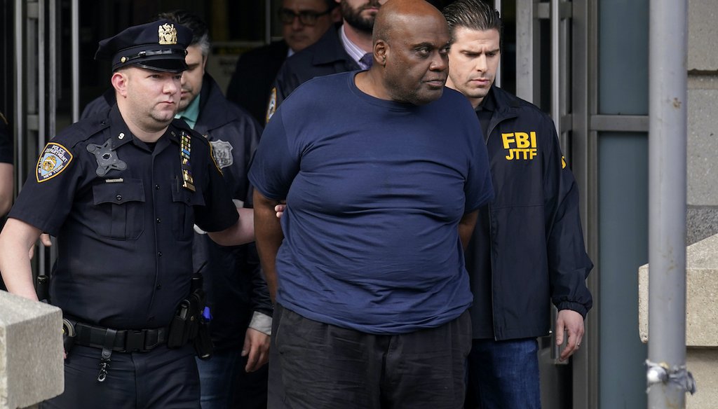 New York City Police, left, and law enforcement officials lead subway shooting suspect Frank R. James, 62, center, away from a police station, in New York, Wednesday, April 13, 2022. (AP)