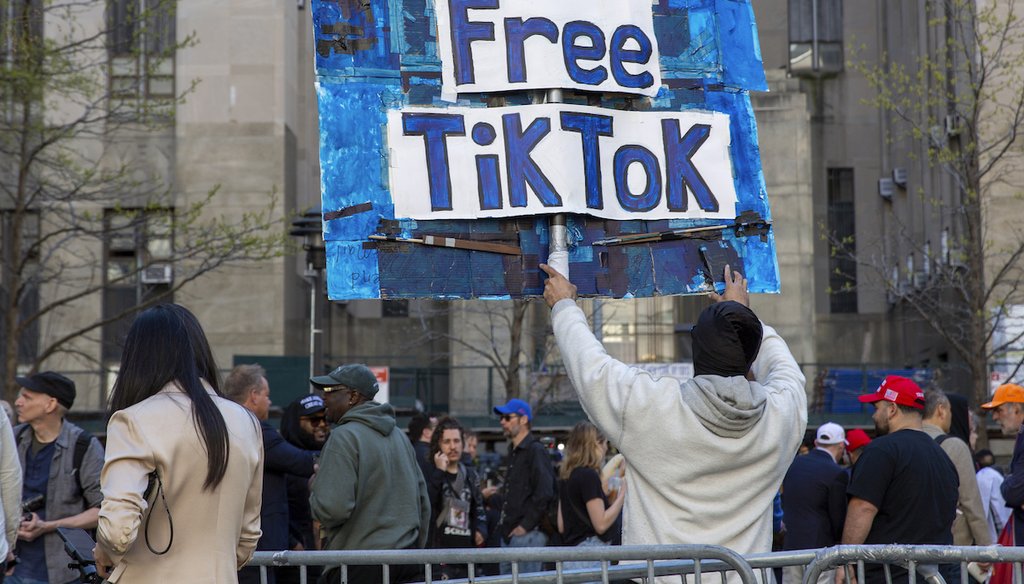 A man carries a Free TikTok sign in front of the courthouse where the hush-money trial of Donald Trump got underway April 15, 2024, in New York. (AP)