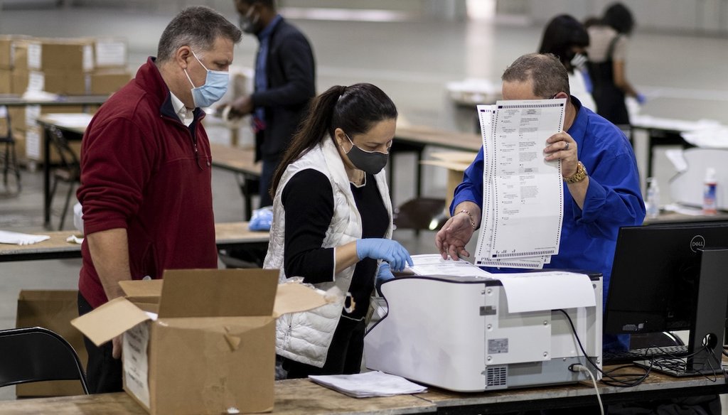 Workers scan ballots as the Fulton County presidential recount gets under way Nov. 25, 2020, at the Georgia World Congress Center in Atlanta. (AP)