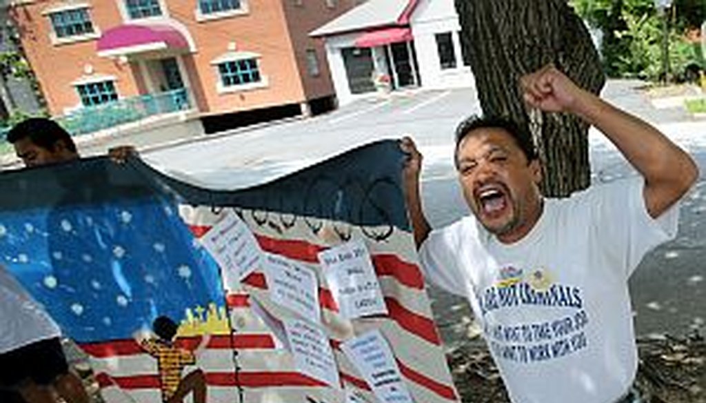 Thomas Martinez chants toward the Georgia GOP headquarters during a rally July 9, 2013. Participants were urging House GOP members to move forward on the Senate's immigration reform bill. (AJC Photo/Jason Getz)
