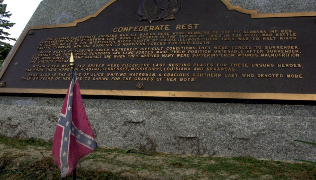 A small confederate flag stands at the base of a stone marking Confederate Rest at the Forest Hill cemetery in Madison in this 2000 file photo. (Milwaukee Journal Sentinel)