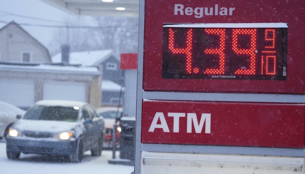 The price regular gas is illuminated on the roadside sign as motorists pull up to the pumps at a service station Wednesday, March 9, 2022, in Denver. (AP Photo/David Zalubowski)