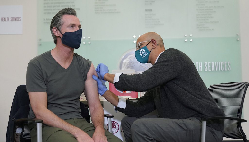 Gov. Gavin Newsom, left, receives a Moderna COVID-19 vaccine booster shot from California Health and Human Services Secretary Dr. Mark Ghaly at Asian Health Services in Oakland, Calif., Oct. 27, 2021. (AP)