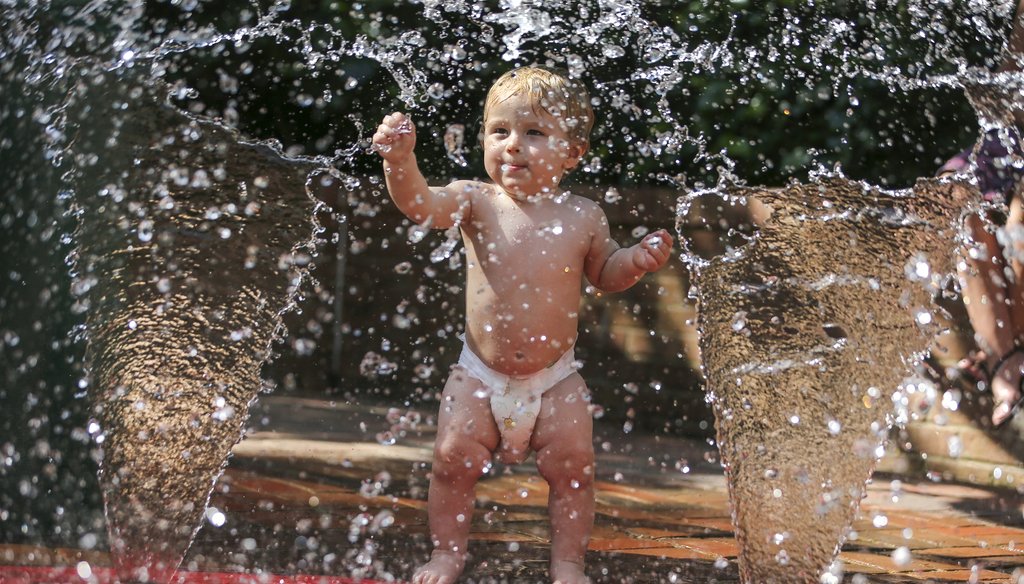 One year old Leif Sedlack-Brown cools off in a fountain this week at the Atlanta Botanical Garden. AJC photo by John Spink / JSpink@ajc.com.