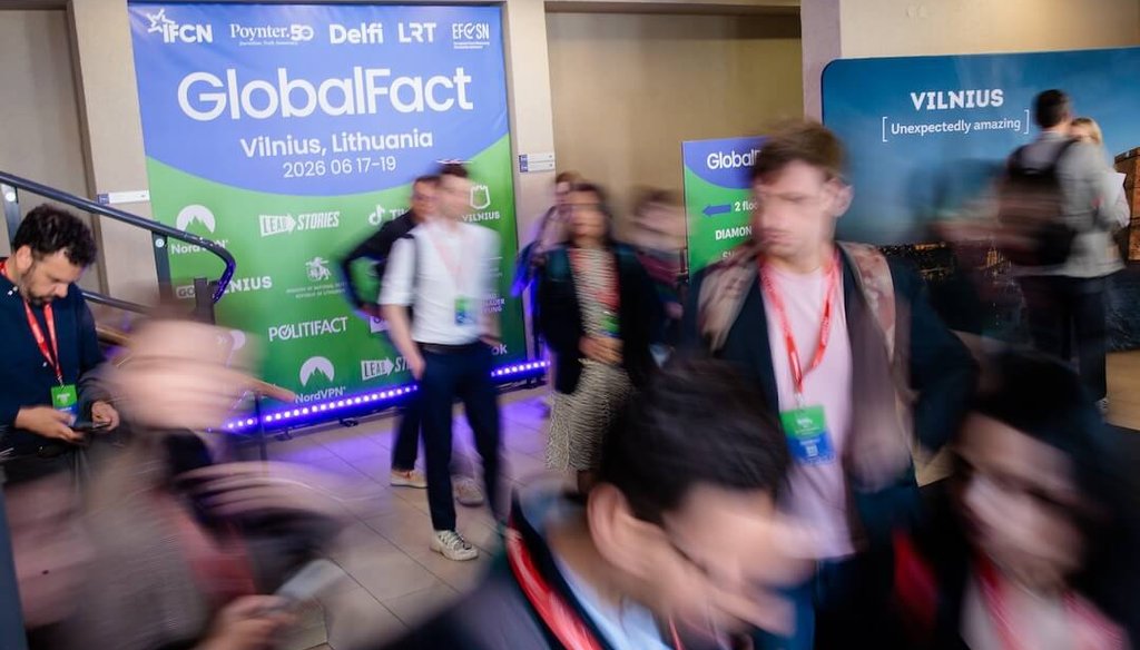 Attendees walk past a GlobalFact sign in Vilnius, Lithuania, on June 18, 2026. The conference highlighted both the challenges facing fact-checkers and the resilience of the global fact-checking movement. (Delfi/Josvydas Elinskas)