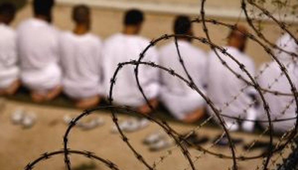 A group of detainees kneels during an early morning Islamic prayer in their camp at the U.S. military prison for "enemy combatants" in Guantanamo Bay, Cuba. President Barack Obama approved the resumption of military trials for detainees.