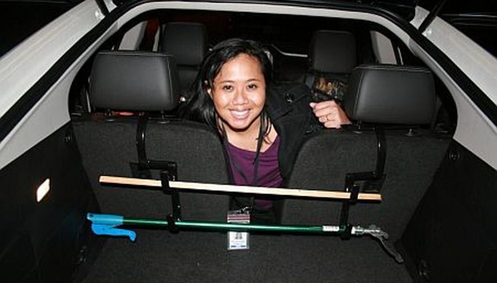 PolitiFact Georgia reporter Willoughby Mariano shows off a gun rack she installed in a Chevy Volt.
