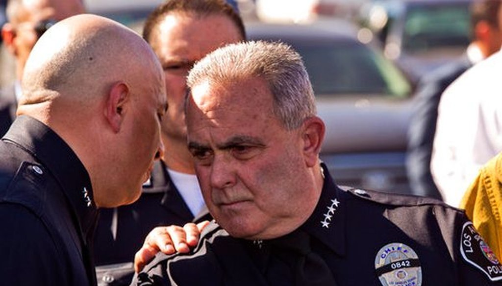 Steve Zipperman, chief of the Los Angeles Unified School District police force, right, is briefed outside the Belmont High School complex on Feb. 1, 2018, after two students were shot and wounded, one critically, inside a Los Angeles middle school.