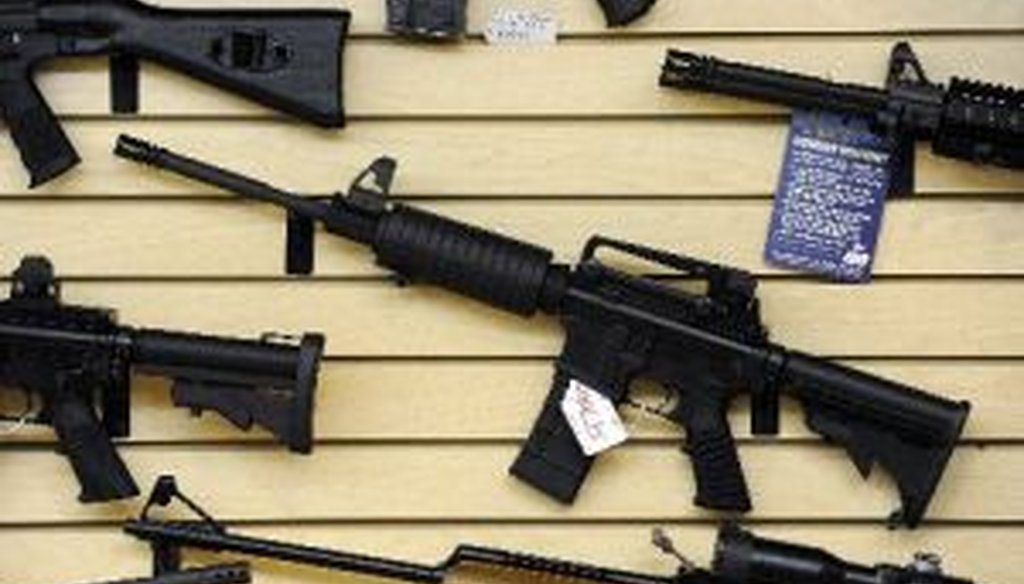 Guns, including an AR-15 semi-automatic rifle, for sale at a shop in Pasadena, Maryland, Jan. 14, 2013.