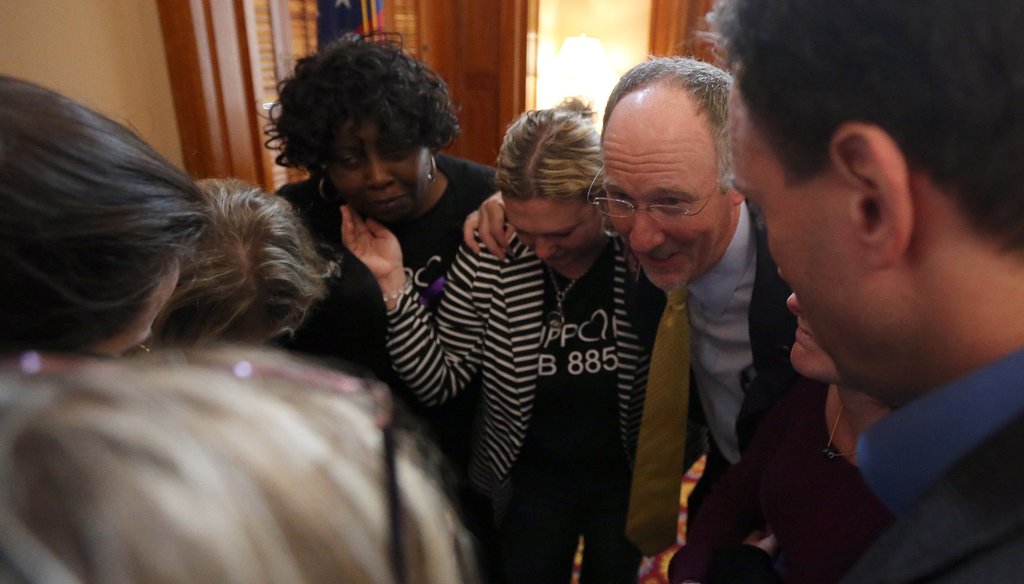 Georgia state Rep. Allen Peake, R-Macon, and supporters of his legislation to provide a form of medical marijuana to seizure patients, huddle after the bill passes one chamber of the state Legislature. Photo Credit: Ben Gray/AJC.