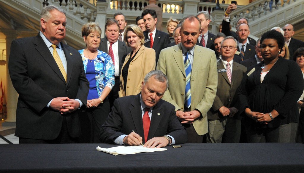 Gov. Nathan Deal signs the bill overhauling the cash-strapped HOPE Scholarship in 2011. Photo by Brant Sanderlin / AJC