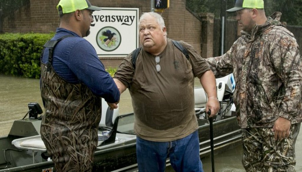 David Emswiler thanks the men rescuing him from his flooded house in Northwest Houston on Aug. 28, 2017. Later, four members of the Texas congressional delegation voted against a plan including hurricane aid (PHOTO: Jay Janner, AUSTIN AMERICAN-STATESMAN).