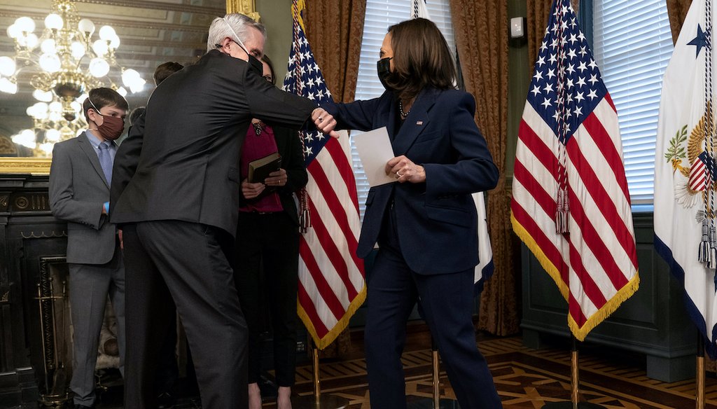 Vice President Kamala Harris, right, and Denis McDonough bump elbows after McDunough was ceremonially sworn in by Harris as secretary of Veterans Affairs, Feb. 9, in Washington. Social media posts falsely claim she said she will close the department. (AP)