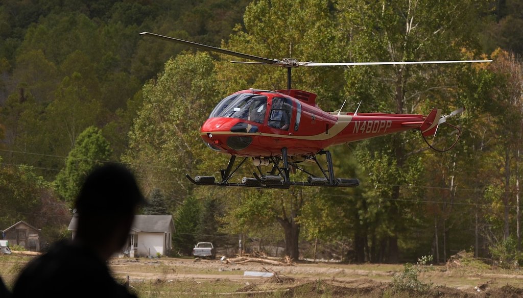 A firefighter watches as a helicopter lands at a volunteer fire station in the aftermath of Hurricane Helene, Thursday, Oct. 3, 2024, in Pensacola, N.C. (AP)