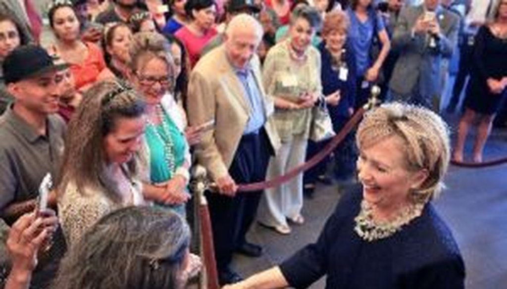 Hillary Clinton laughs while talking with Intertech Plastics employees in Denver, on June 2, 2014. The former secretary of state and possible presidential candidate stopped by the company to learn more about its training and mentoring of young workers.