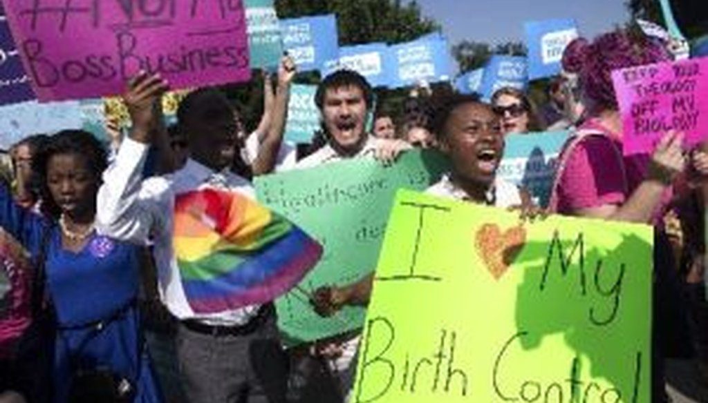 Activists react outside the Supreme Court after the justices ruled, 5-4, in favor of retailer Hobby Lobby in a closely-watched case on religious liberty and contraception.
