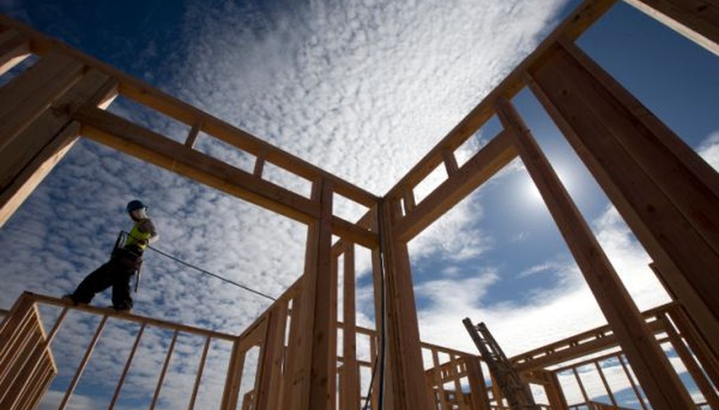 Construction worker Elabert Salazar works on a house frame for a new home in Chula Vista, Calif., in this Nov. 16, 2012, file photo.