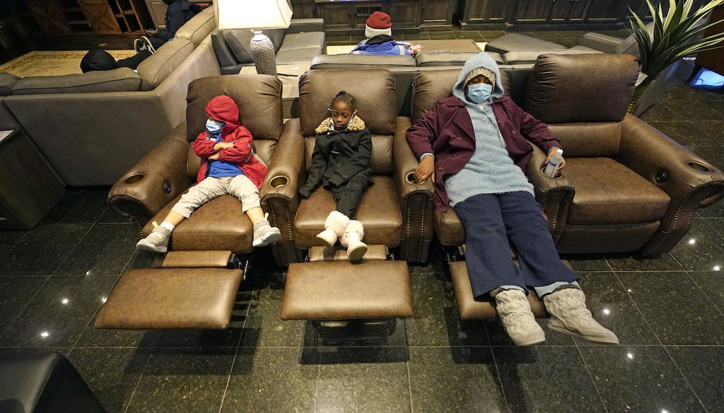 Joecyah Heath, left, Morning Day, center, and Jenesis Heath rest in recliners at a Gallery Furniture store which opened as a shelter Wednesday, Feb. 17, 2021, in Houston. (AP)