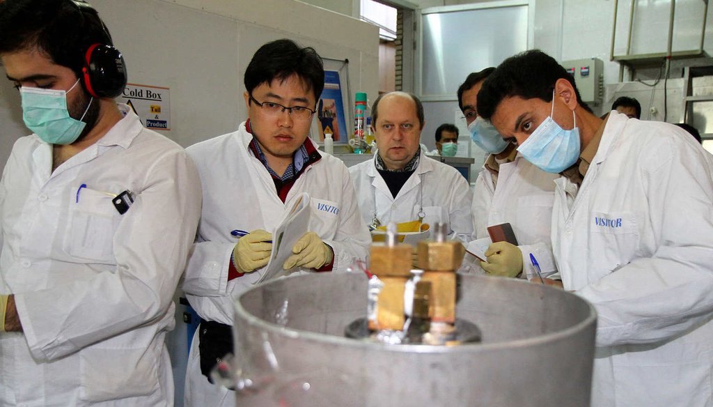 International Atomic Energy Agency inspectors and Iranian technicians stop a uranium enrichment process at the Natanz facility, Jan. 20, 2014 (AP)