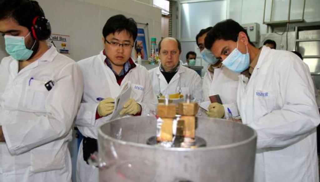 International Atomic Energy Agency inspectors and Iranian technicians cut connections between twin cascades for 20 percent uranium enrichment at the Natanz facility in Iran on Jan. 20, 2014. 