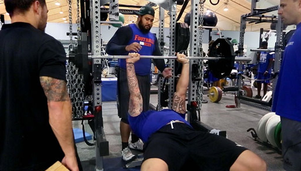 Jon Halapio, a guard for the Denver Broncos, spots Taylor Lewan, offensive tackle for the Tennessee Titans at IMG Academy in Bradenton while trainers watch on March 26, 2015. (Times file photo)