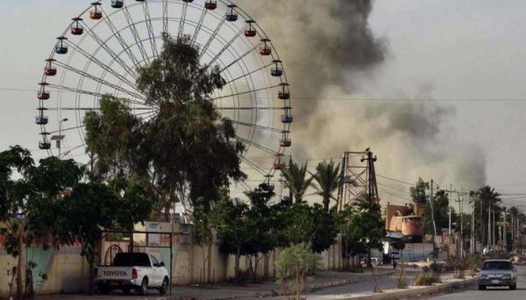 A plume of smoke rises after a May 9, 2015, airstrike by the U.S.-led coalition against ISIS positions in an eastern neighborhood of Ramadi, Iraq, 70 miles west of Baghdad.