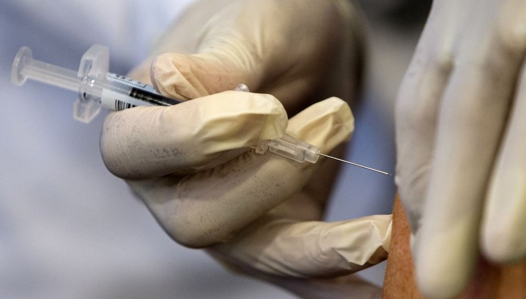 A nurse administers a flu vaccine shot in Washington. (2015 AP Photo)