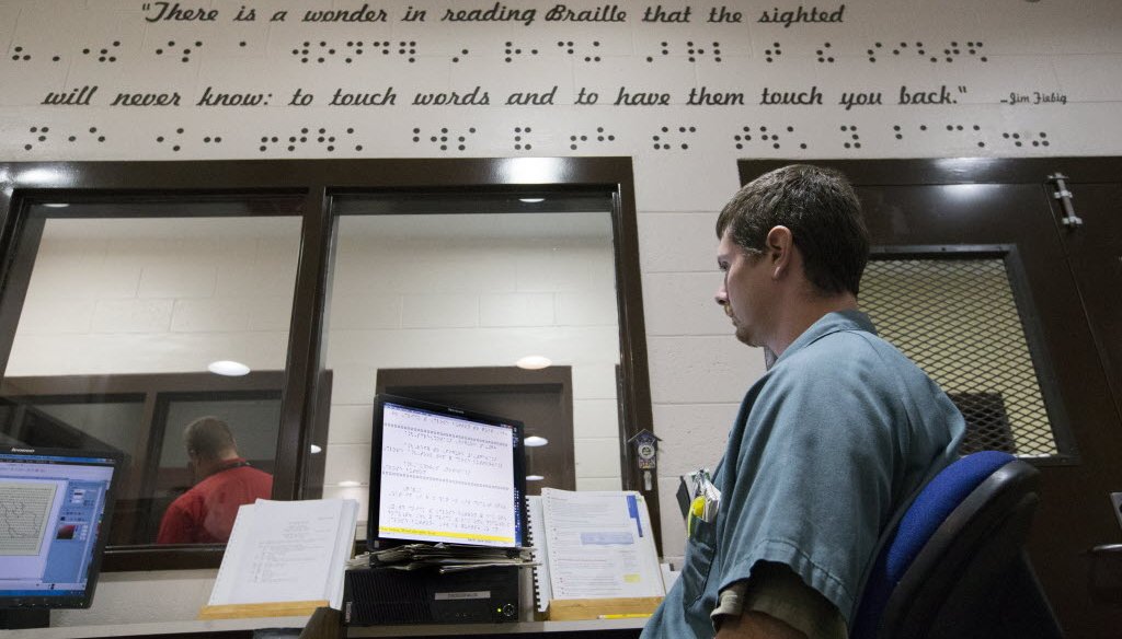An inmate proofreads his work while transcribing books into braille for the blind at the Oshkosh Correctional Institution in Oshkosh, Wis. (Milwaukee Journal Sentinel/Mark Hoffman)